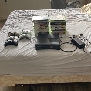 Xbox 360 console with 5 controllers and 30 games. Everything works